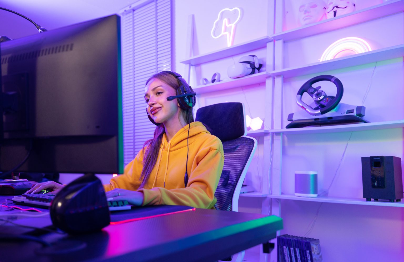 A determined online streamer creates a stream and grows an audience that can generate income through subscriptions and advertising. A contemporary, colorful, and artificially lights home office.